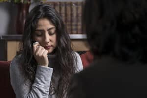A woman learns about a substance abuse treatment center