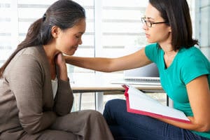 A woman consults another woman about a morphine addiction treatment center