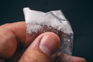 A man holding synthetic drugs