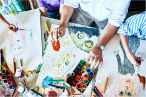 Hands of people engaged in art therapy